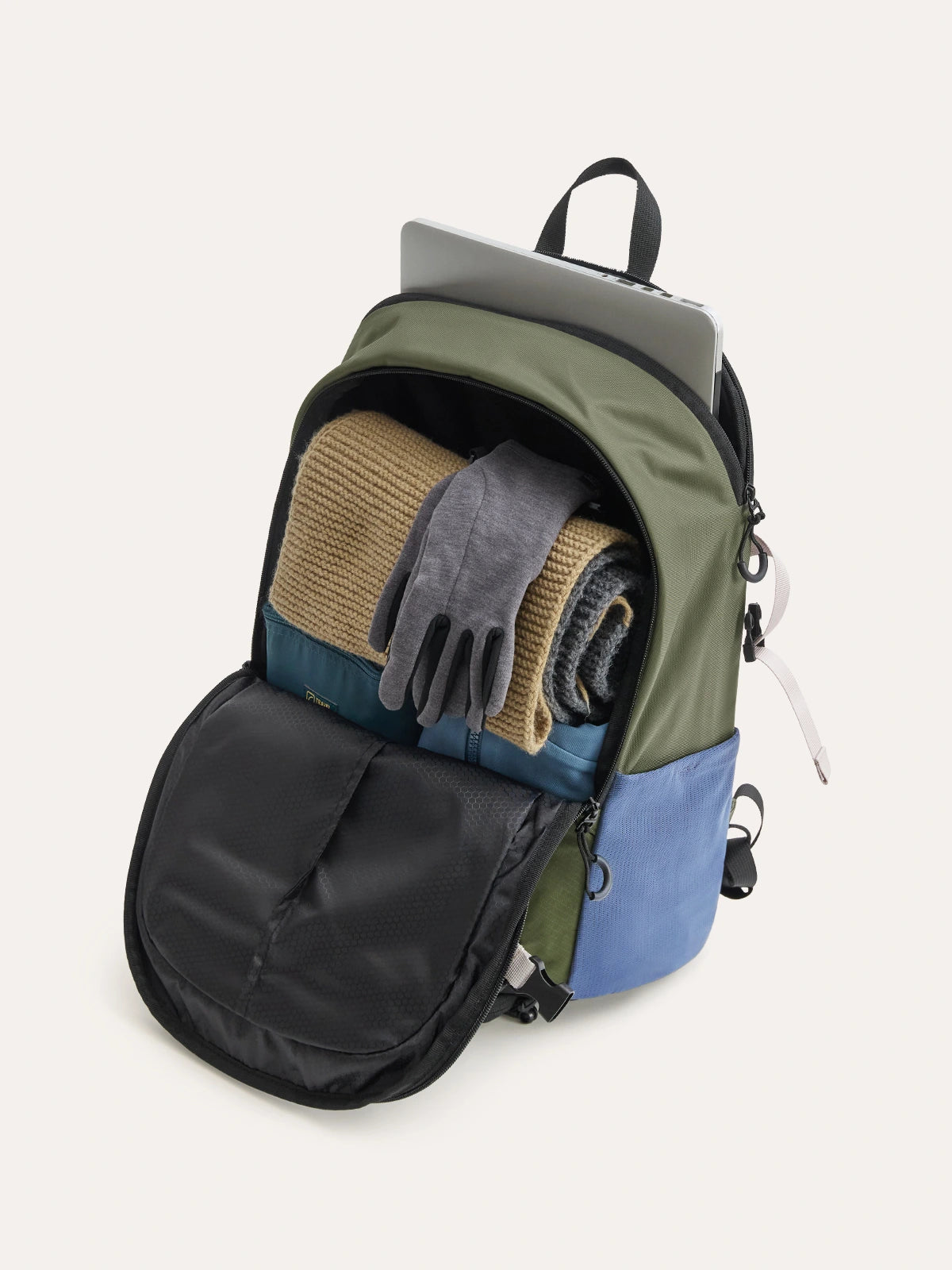 Backpack with laptop compartment, multiple pockets, and space for outdoor gear, shown with a laptop and clothing inside